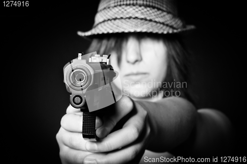 Image of Girl in hat with a big pistol