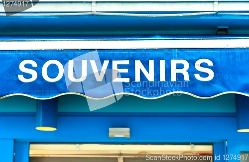 Image of souvenirs sign on wet blue surface