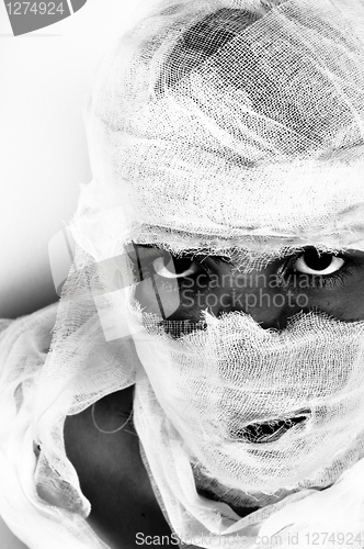 Image of Scary portrait of a girl wrapped in bandage