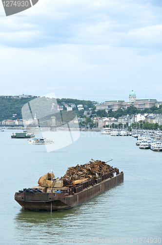 Image of Boat with metal junk floating on water