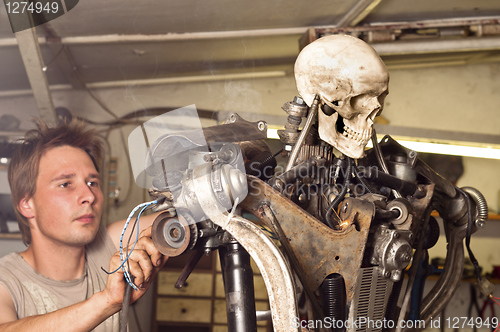 Image of Young worker finishing his robot