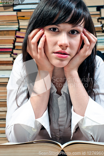 Image of Young college girl with book opened 