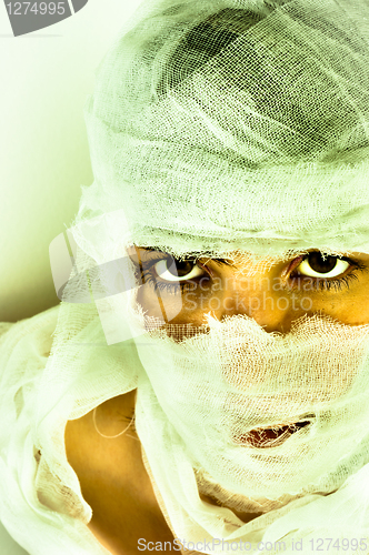 Image of Scary portrait of a girl wrapped in bandage