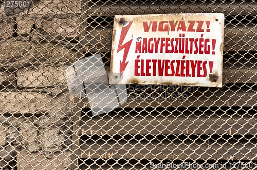 Image of Danger! High voltage sign on metal fence