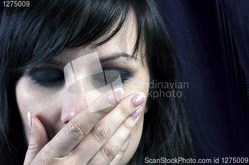 Image of Young girl covering her mouth with her hand in black and white