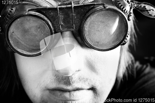 Image of Young survivor of the apocalypse in goggles with light