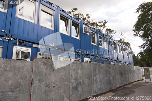 Image of Containers piled up before fence