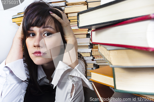 Image of Young student girl with worried expression on her face