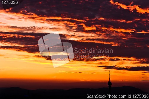 Image of Dark storm clouds with red light