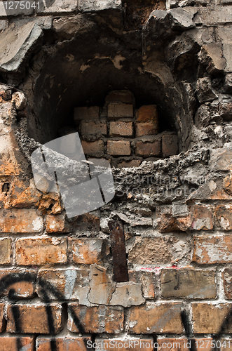 Image of Hole in abandoned brick wall