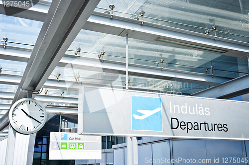 Image of Departure sign at airport with airplane