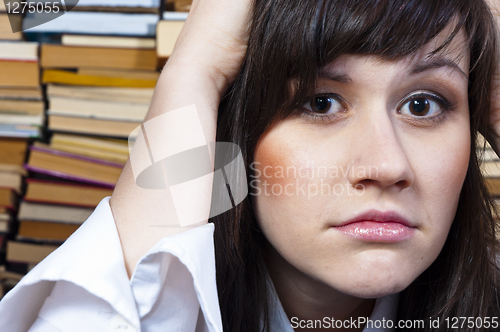 Image of Young student girl with worried expression on her face