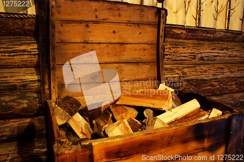 Image of Foto of firewood in old wood chest