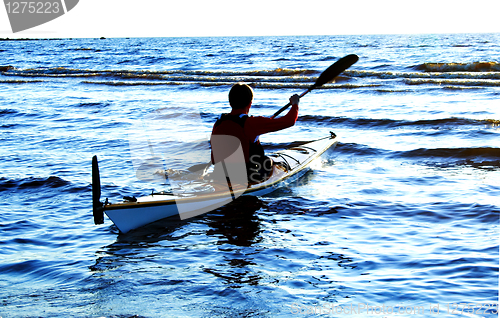 Image of One man on canoe against sea wawes