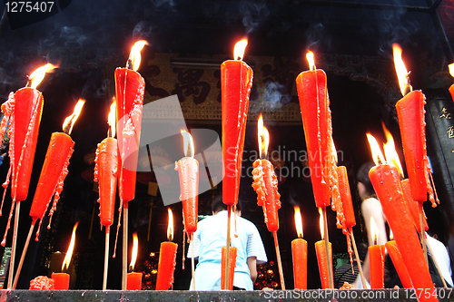 Image of Joss sticks and candles burning at a temple