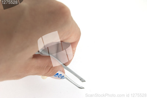 Image of A woman hand with a tweezer