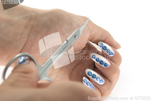 Image of A woman hand with scissors