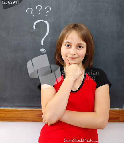 Image of Young elementary school girl thinking