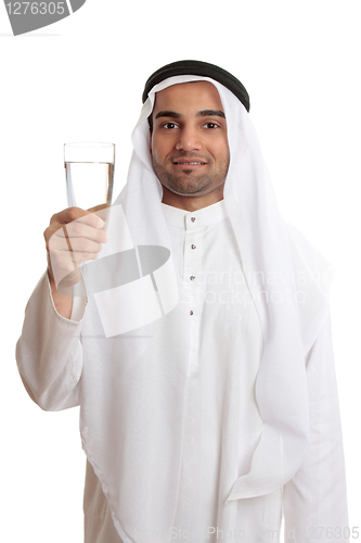 Image of Happy arab man holding a glass of fresh drinking water