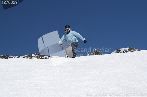 Image of Snowboarder descends a slope