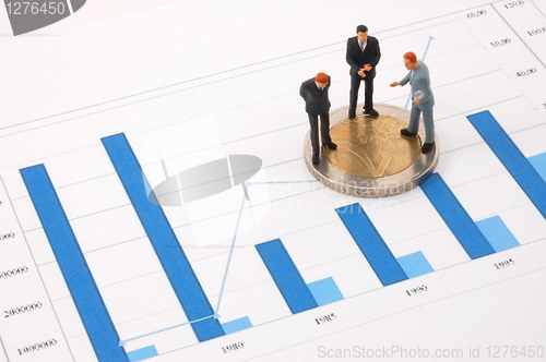 Image of businessman and money over a chart