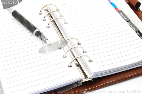 Image of business organizer and pen