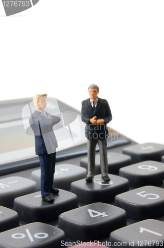 Image of business people on calculator isolated