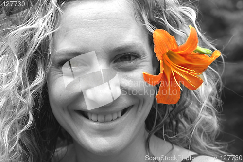 Image of Girl with orange flower behind her ear