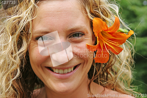 Image of Girl with orange flower behind her ear