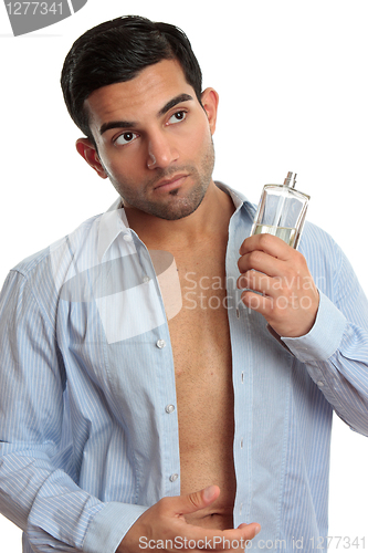 Image of Man with cologne while dressing