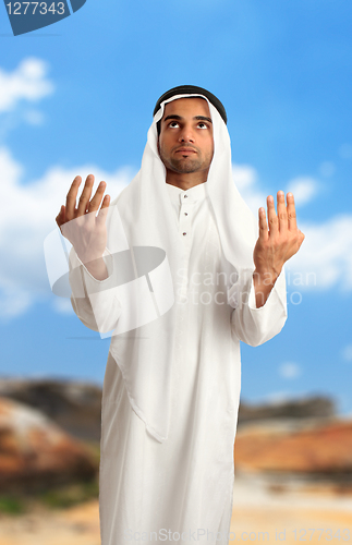 Image of Middle eastern arab man with arms outstretched