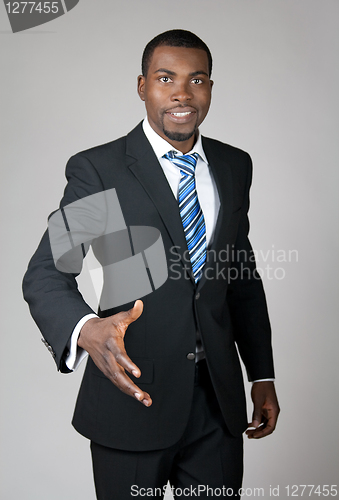 Image of Smiling successful businessman giving hand