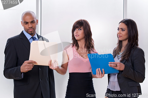 Image of Young woman giving tasks to her colleagues