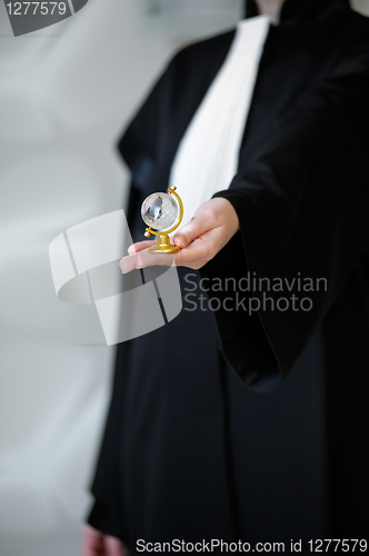 Image of Barrister in wig holding globe in hand