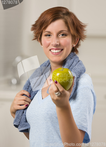 Image of Pretty Red Haired Woman with Towel Holding Green Apple