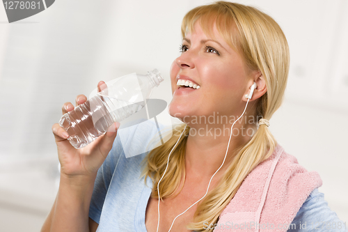 Image of Pretty Blonde Woman with Towel Drinking From Water Bottle