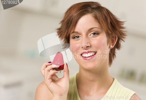 Image of Pretty Red Haired Woman Holding Strawberry