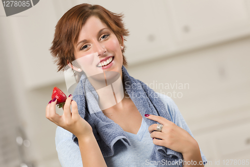 Image of Pretty Red Haired Woman Holding Strawberry