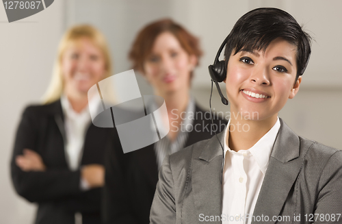 Image of Pretty Hispanic Businesswoman with Colleagues Behind