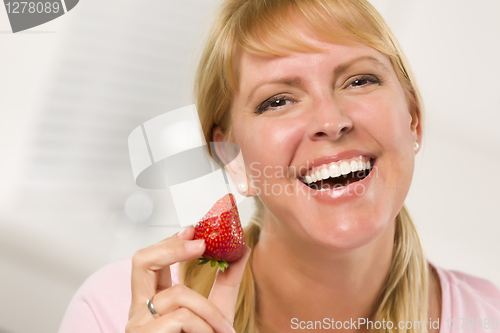 Image of Pretty Smiling Blonde Woman Holding Strawberry