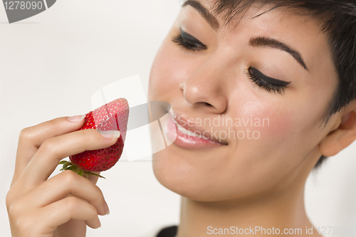 Image of Pretty Hispanic Woman Holding Strawberry