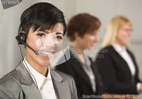 Image of Pretty Hispanic Businesswoman with Colleagues Behind