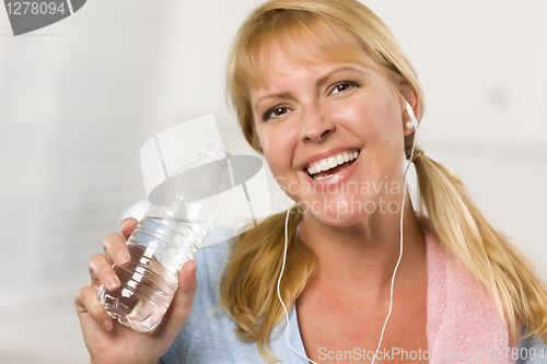 Image of Pretty Blonde Woman with Towel Drinking From Water Bottle
