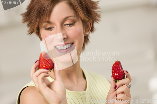 Image of Pretty Red Haired Woman Holding Strawberry