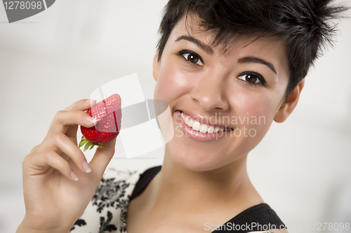 Image of Pretty Hispanic Woman Holding Strawberry