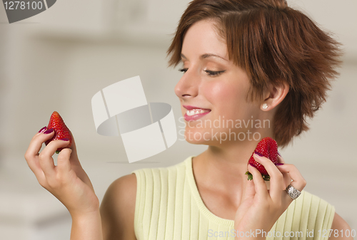 Image of Pretty Red Haired Woman Holding Strawberry