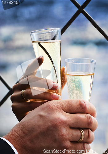 Image of Two hands holding wedding champagne