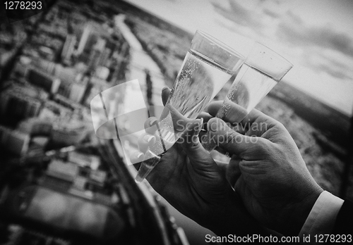Image of Two hands holding wedding champagne