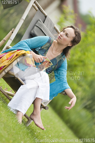 Image of Young woman relaxing on nature