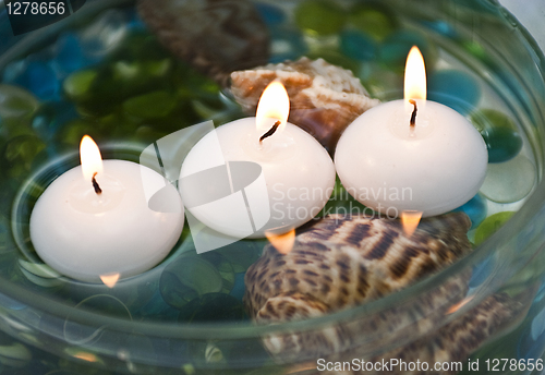 Image of Three burning candles and shell